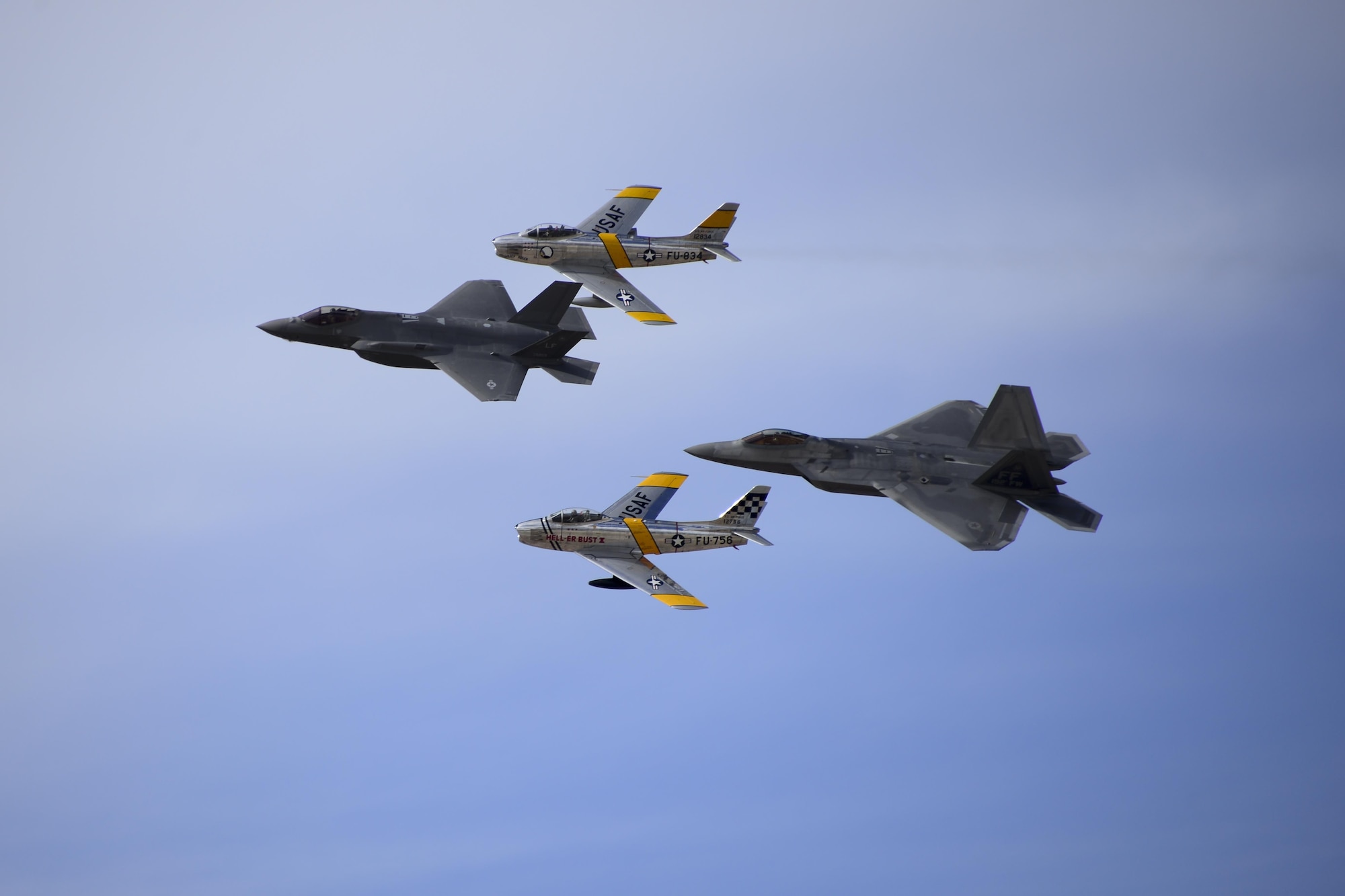 A U.S. Air Force F-22 Raptor, a F-35 Lightning II and two F-86 Sabre's fly in fomration during the 2017 Heritage Flight Training and Certification Course at Davis-Monthan Air Force Base, Ariz., Feb. 12, 2017. The annual aerial demonstration training event has been held at D-M since 2001. The course featured aerial demonstrations from historic and modern fighter aircraft. (U.S. Air Force photo by Senior Airman Betty R. Chevalier)