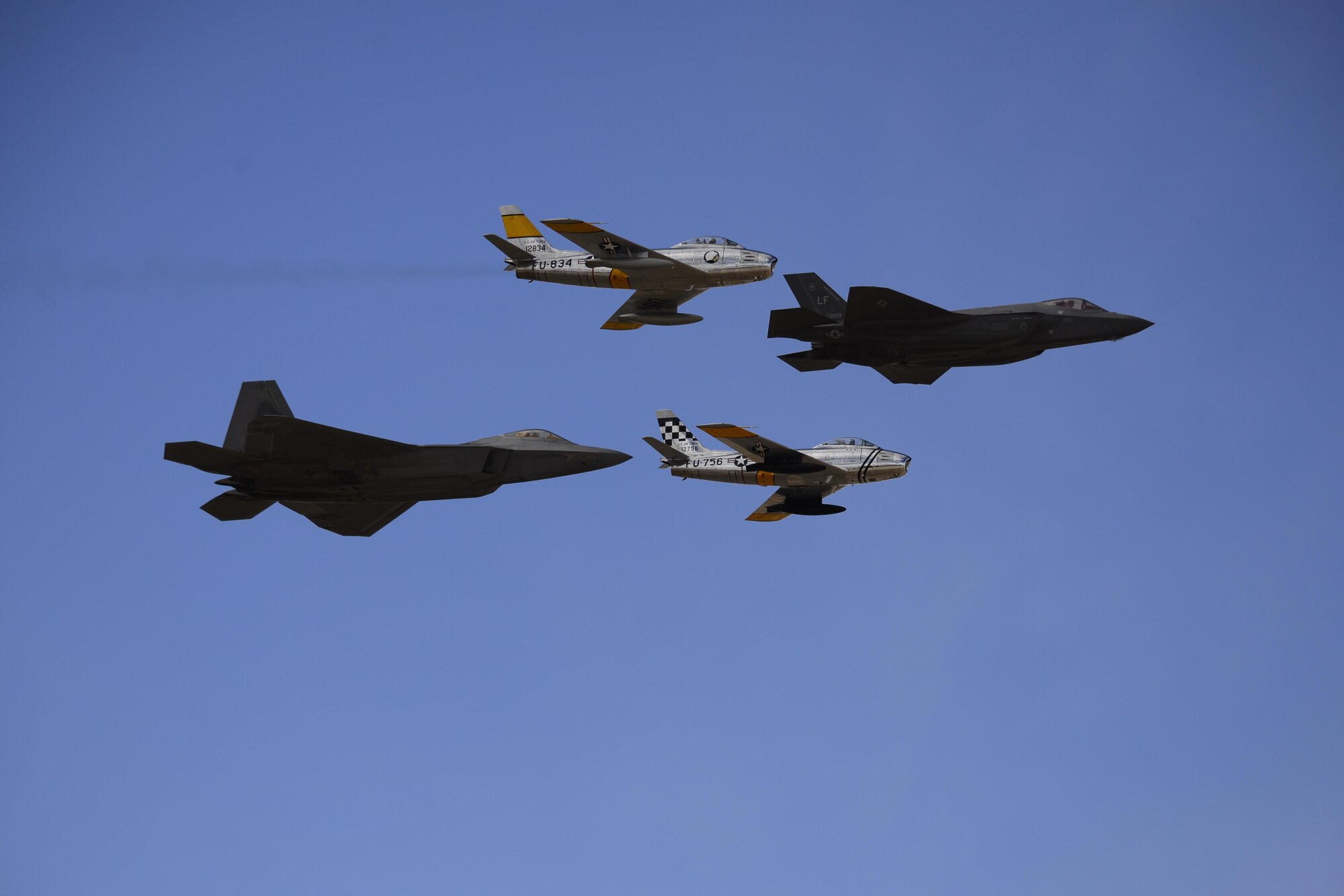 A U.S. Air Force F-22 Raptor, a F-35 Lightning II and two F-86 Sabre's fly in formation during the 2017 Heritage Flight Training and Certification Course at Davis-Monthan Air Force Base, Ariz., Feb. 12, 2017. The HFTCC provides civilian and military pilots the opportunity to practice flying in formation together in preparation for future air shows. (U.S. Air Force photo by Senior Airman Betty R. Chevalier)
