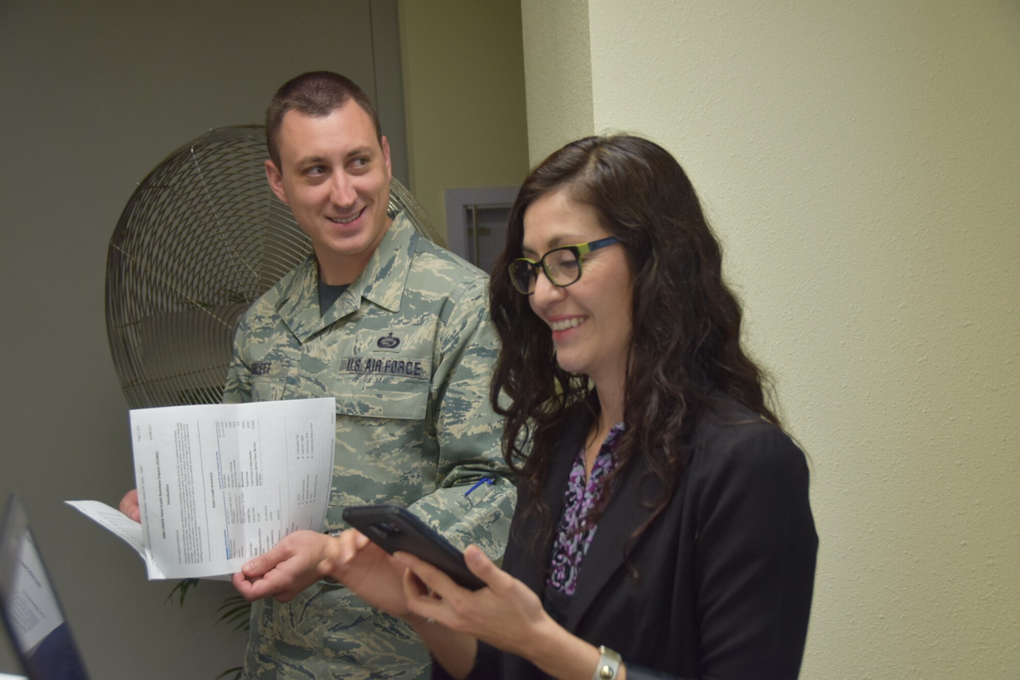 Tech. Sgt. Brian Boblett, a 433rd Force Support Squadron readiness NCO waits as Geremy Chavez, a Personal Financial Counselor , calculates his retirement points. Chavez also offered guidance on tax preparation. (U.S. Air Force photo/Tech. Sgt. Carlos J. Treviño)