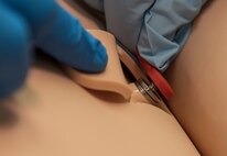 U.S. Air Force Airmen with the 35th Medical Group attach a lead to a Laerdal mannequin at Misawa Air Base, Japan, Feb. 3, 2017. The mannequins have the ability to simulate breathing, eye dilations, pulses, speaking and reacting to medications administered through computer codes. They allow for as close-to-realistic training as possible for personnel. (U.S. Air Force photo by Airman 1st Class Sadie Colbert)