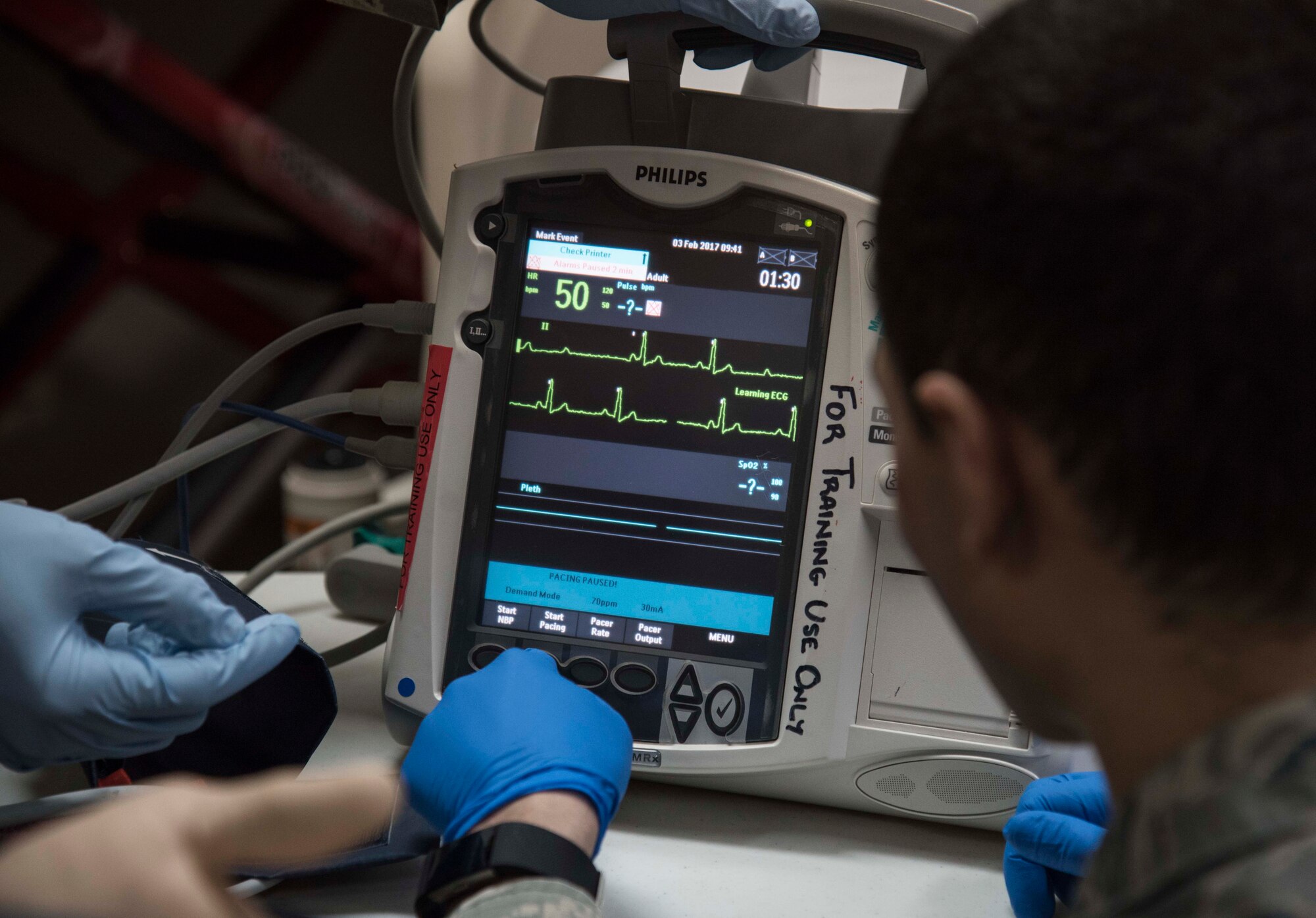 U.S. Air Force Airmen with the 35th Medical Group, prepare a Philips HeartStart MRx defibrillator and heart monitor during training at Misawa Air Base, Japan, Feb. 3, 2017.  The tool includes automated external defibrillation capabilities with patient monitoring attributes allowing technicians to clearly assess the situation at all times. (U.S. Air Force photo by Airman 1st Class Sadie Colbert)