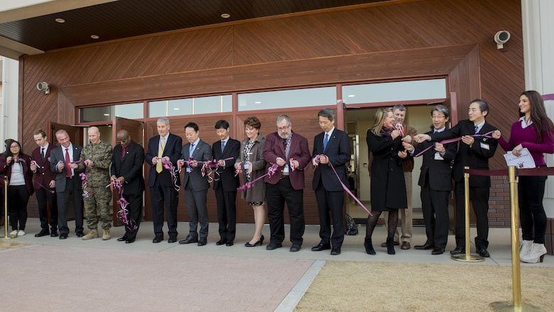 Students and staff, service members and civilian personnel cut ribbons during the Matthew C. Perry High School ribbon-cutting ceremony at Marine Corps Air Station Iwakuni, Japan, Feb. 3, 2017. The new 165,000 square foot high school is located next to the Kawashimo housing area provides improved security, resources and opportunities for students and staff. U.S. Marine Corps Col. Richard F. Fuerst, commanding officer of MCAS Iwakuni, Lorenzo Brown, principal of M.C. Perry High School, Jeffrey Carr, assistant principal of M.C. Perry High School, Yoshihiko Fukuda, mayor of Iwakuni City, and Iwakuni officials conducted the ribbon-cutting ceremony, signifying the grand opening of the new facility. (U.S. Marine Corps photo by Cpl. Aaron Henson)