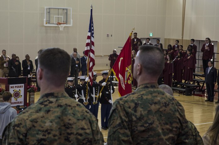 Students and staff, service members and civilian personnel stand at attention while the Matthew C. Perry Reserve Officers' Training Corps color guard presents colors during the Matthew C. Perry High School ribbon cutting ceremony at Marine Corps Air Station Iwakuni, Japan, Feb. 3, 2017. Construction of the new $67 million school began August 2014 and finished August 2016. The school includes a 400 meter track, artificial turf soccer and football field, a concession stand and 1,000 seat spectator grandstand. Replacing the old 38,000 square foot high school built in 1986 and costing approximately $3 million, the new high school provides improved security, resources and opportunities for students and staff. (U.S. Marine Corps photo by Cpl. Aaron Henson)