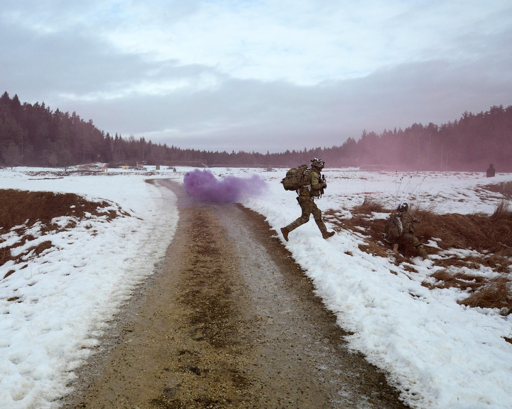 A soldier runs to take cover during a live-fire exercise at Grafenwoehr Training Area, Germany, Feb. 6, 2017. The soldier is a paratrooper assigned to 2nd Battalion, 503rd Infantry Regiment, 173rd Airborne Brigade. Army photo by Matthias Fruth