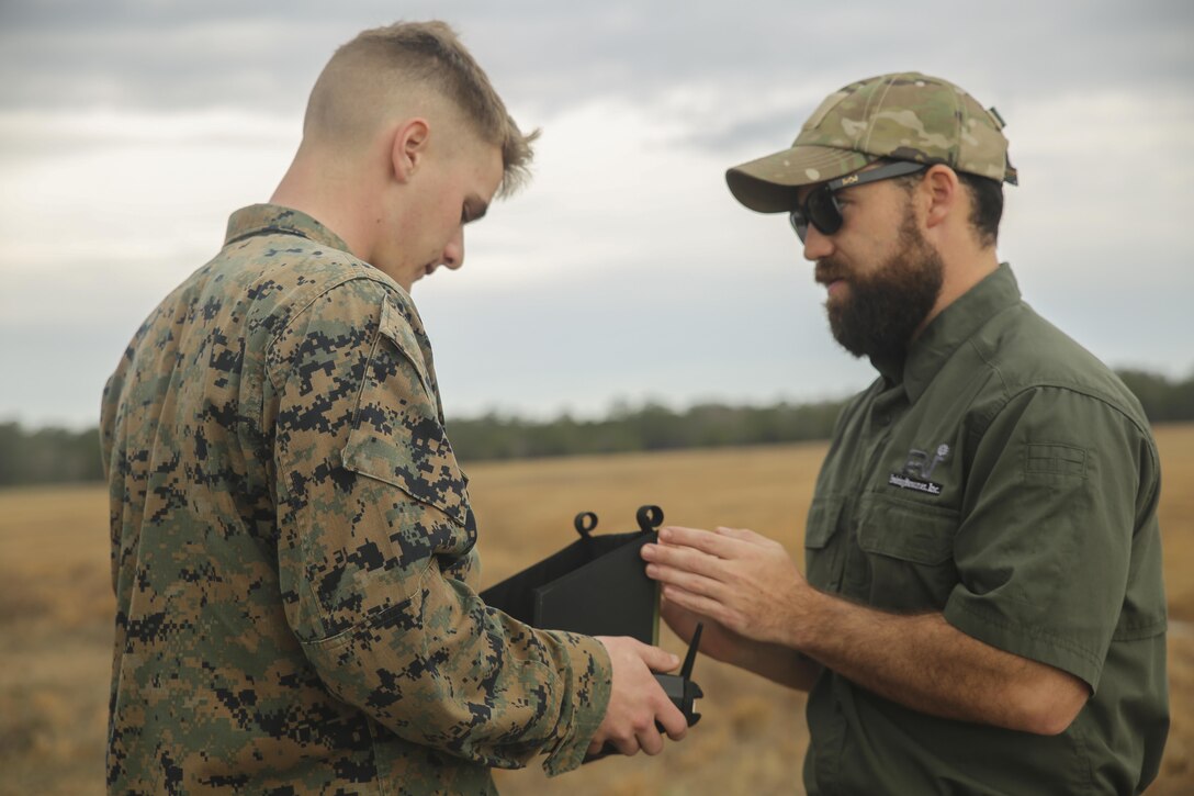 Shaun Sorensen, right, a small unmanned aerial systems instructor with Training and Logistics Support Activity, instructs a Marine with Task Force Southwest on proper controls for the Instant Eye SUAS at Camp Lejeune, N.C., Feb. 8, 2017. The Instant Eye is the first drone in the Marine Corps’ repertoire that can launch and land without a runway or manpower assistance. Approximately 300 Marines are assigned to Task Force Southwest, whose mission will be to train, advise and assist the Afghan National Army 215th Corps and 505th Zone National Police. (U.S. Marine Corps photo by Sgt. Lucas Hopkins)