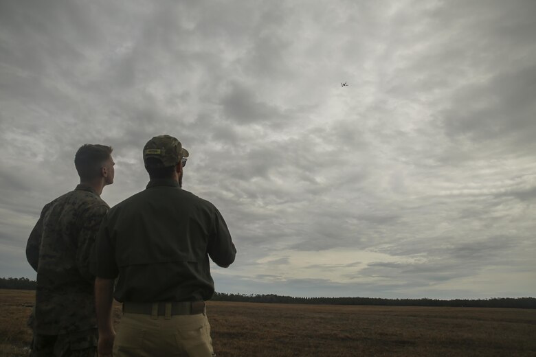 Shaun Sorensen, right, a small unmanned aerial systems instructor with Training and Logistics Support Activity, and a Marine with Task Force Southwest, left, fly the Instant Eye SUAS at Camp Lejeune, N.C., Feb. 8, 2017. The Instant Eye is revolutionary in that it can fly easily into buildings, over walls and hills, and can take off and land vertically. Approximately 300 Marines are assigned to Task Force Southwest, whose mission will be to train, advise and assist the Afghan National Army 215th Corps and 505th Zone National Police. (U.S. Marine Corps photo by Sgt. Lucas Hopkins)