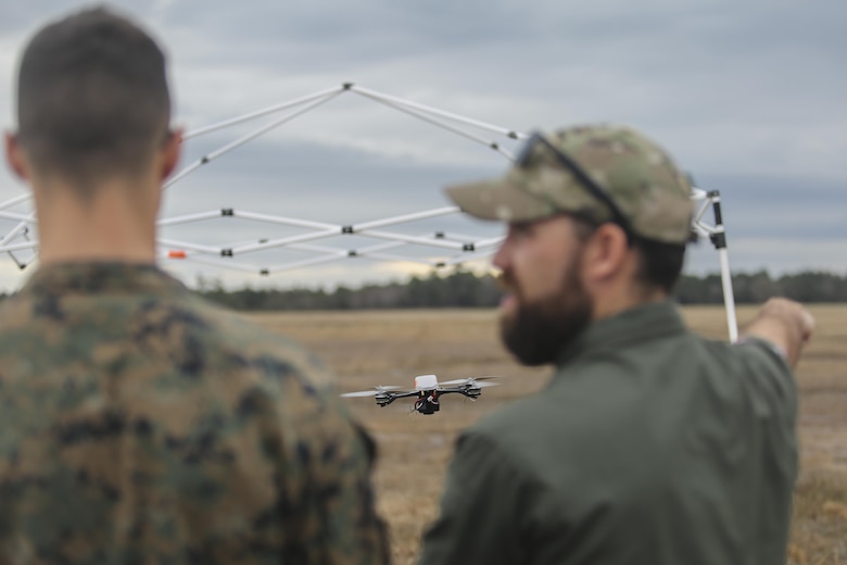 Shaun Sorensen, right, a small unmanned aerial systems instructor with Training and Logistics Support Activity, instructs a Marine with Task Force Southwest, left, on flying maneuvers of the Instant Eye SUAS at Camp Lejeune, N.C., Feb. 8, 2017. The Instant Eye is revolutionary in that it can fly easily into buildings, over walls and hills, and can take off and land vertically. Approximately 300 Marines are assigned to Task Force Southwest, whose mission will be to train, advise and assist the Afghan National Army 215th Corps and 505th Zone National Police. (U.S. Marine Corps photo by Sgt. Lucas Hopkins)