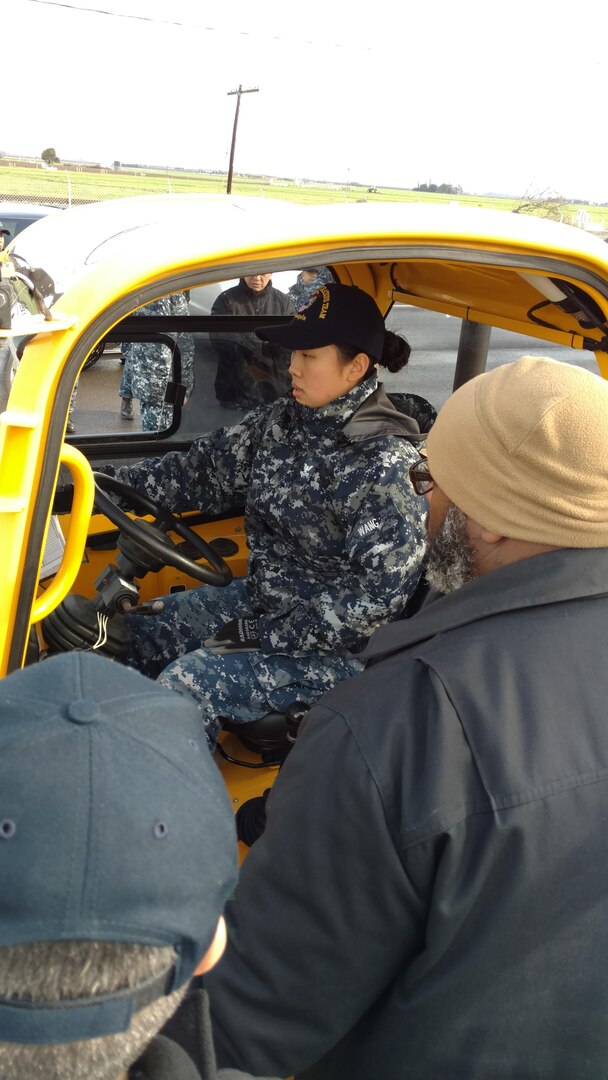 Logistics Specialist 2nd Class Xuan Wang becomes familiar with the Sellick forklift that DDXX uses in its mission.  