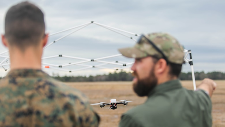 Shaun Sorensen, right, a small unmanned aerial systems instructor with Training and Logistics Support Activity, instructs a Marine with Task Force Southwest, left, on flying maneuvers of the Instant Eye SUAS at Marine Corps Base Camp Lejeune, North Carolina, Feb. 8, 2017. The Instant Eye is revolutionary in that it can fly easily into buildings, over walls and hills, and can take off and land vertically. Approximately 300 Marines are assigned to Task Force Southwest, whose mission will be to train, advise and assist the Afghan National Army 215th Corps and 505th Zone National Police. 