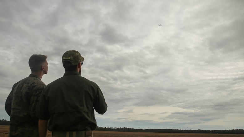 Shaun Sorensen, right, a small unmanned aerial systems instructor with Training and Logistics Support Activity, and a Marine with Task Force Southwest, left, fly the Instant Eye SUAS at Marine Corps Base Camp Lejeune, North Carolina, Feb. 8, 2017. The Instant Eye is revolutionary in that it can fly easily into buildings, over walls and hills, and can take off and land vertically. Approximately 300 Marines are assigned to Task Force Southwest, whose mission will be to train, advise and assist the Afghan National Army 215th Corps and 505th Zone National Police. 