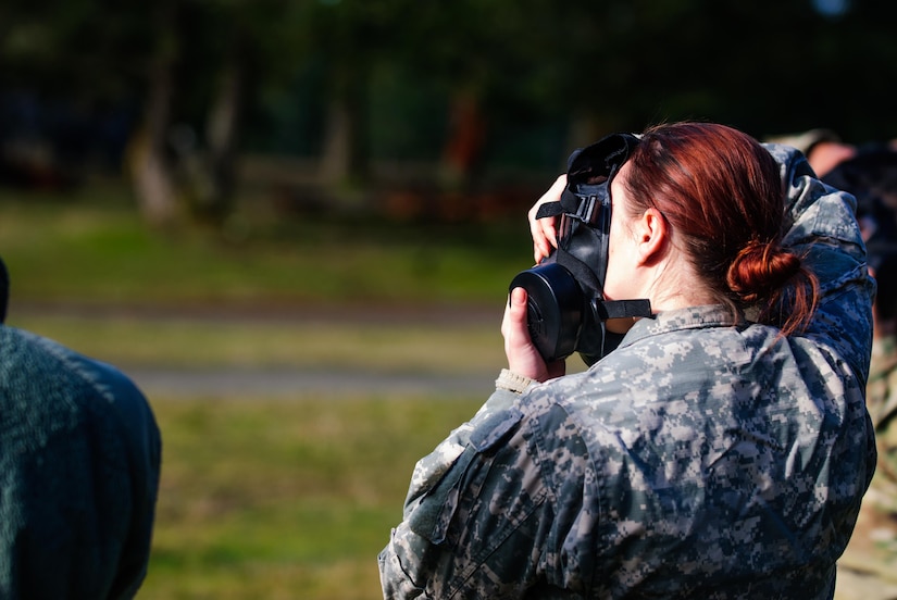 A soldier from Headquarters and Headquarters Company, 301st Maneuver Enhancement Brigade, checks her mask for a proper seal at the Chemical, Biological, Radiological and Nuclear training held at Joint Base Lewis-McChord, Washington, January 21, 2017. The purpose of the training was to familiarize soldiers with the M50 Joint Service General Purpose Mask, and to ensure that they are prepared to respond to a CBRN incident or attack. 