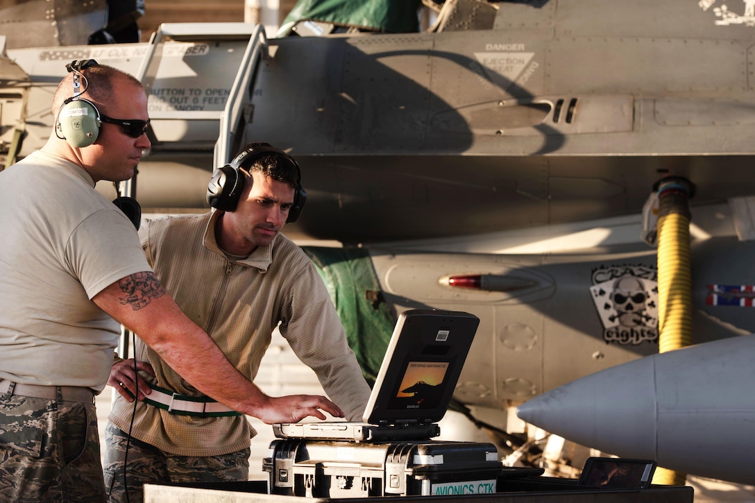 Air Force Tech. Sgt. Alex Babbie and Senior Airmen Josh Clemons reprogram the common central interface unit on an F-16 Fighting Falcon in Southwest Asia, Feb. 6, 2017. Babbie and Clemons are avionics specialists assigned to the Vermont Air National Guard’s 407th Expeditionary Maintenance Squadron. 