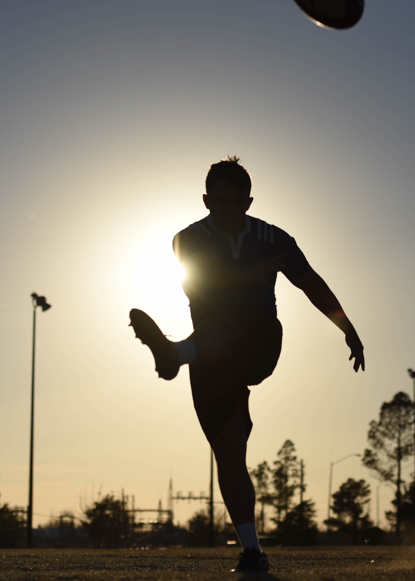 U.S. Air Force 2nd Lt. Jacob Kirkland, 97th Contracting Flight contracting specialist, kicks a rugby ball, Feb. 10, 2017, Altus Air Force Base, Oklahoma. Kirkland was selected to play on the USAF rugby sevens team in the Las Vegas Invitation tournament, March 3-5. (U.S. Air Force photo by Senior Airman Nathan Clark/Released)