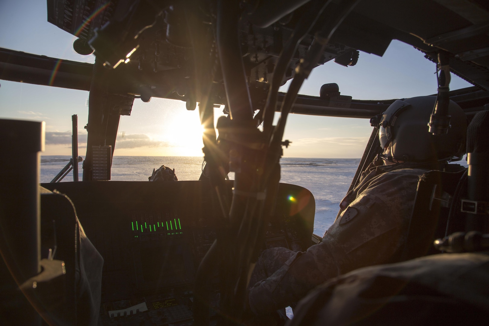 Chief Warrant Officer 2 Josh Claeyes, a UH-60 Black Hawk pilot with Bravo Company, 1st Battalion, 207th Aviation Regiment, flies across the Bethel tundra during a training mission in western Alaska, Jan. 13, 2017.  Crew from the 207th located and assisted a couple stranded when their snowmobile became stuck.