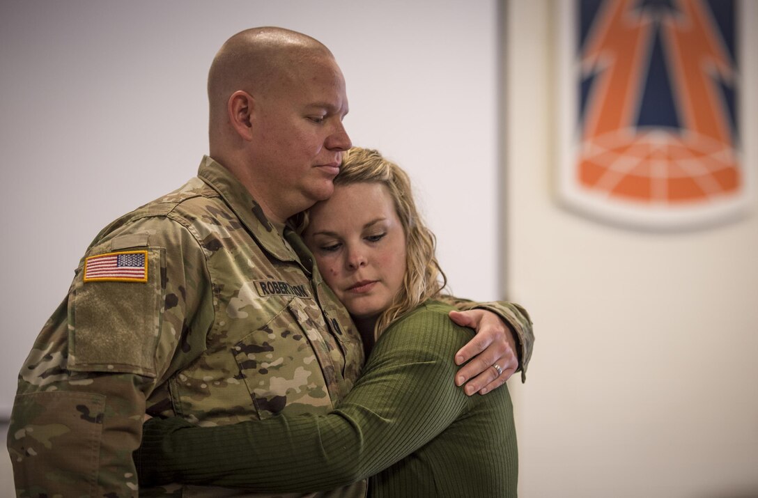 U.S. Army Reserve Capt. Mike Roberston, a logistics officer for Detachment 6, 335th Signal Command (Theater), shares a quiet moment with his wife, Erin, before a deployment ceremony for Det. 6 at the command headquarters in East Point, Ga., Feb. 12, 2017. The detachment left for a a nine-month deployment to the Middle East after the ceremony. 