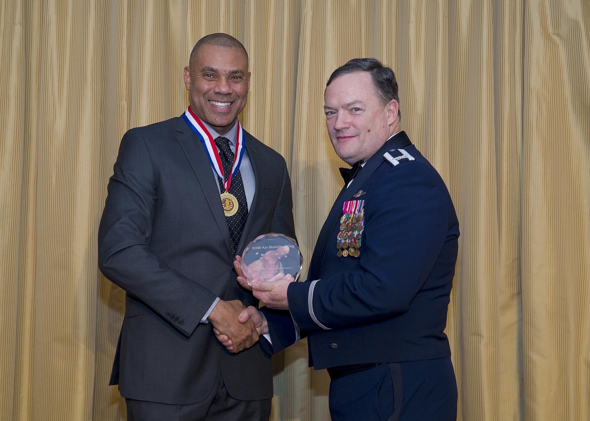 John Fielding, 514th Maintenance Group, receives the Outstanding Civilian award, category II, from Col. David Pavey, 514th Air Mobility Wing commander, during the wing's annual awards banquet Feb. 11.