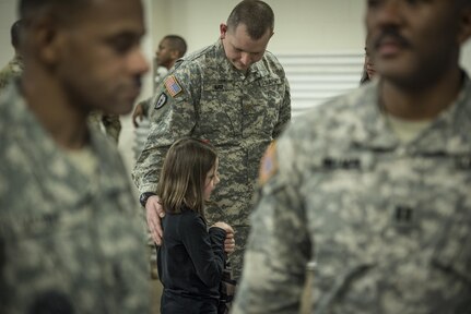 U.S. Army Reserve Maj. Christopher Nau, the officer in charge of Detachment 6, 335th Signal Command (Theater), comforts his daughter, Isabella, 9, during a deployment ceremony for Det. 6 at the command headquarters in East Point, Ga., Feb. 12, 2017. The detachment was leaving for a nine-month mission in the Middle East. 