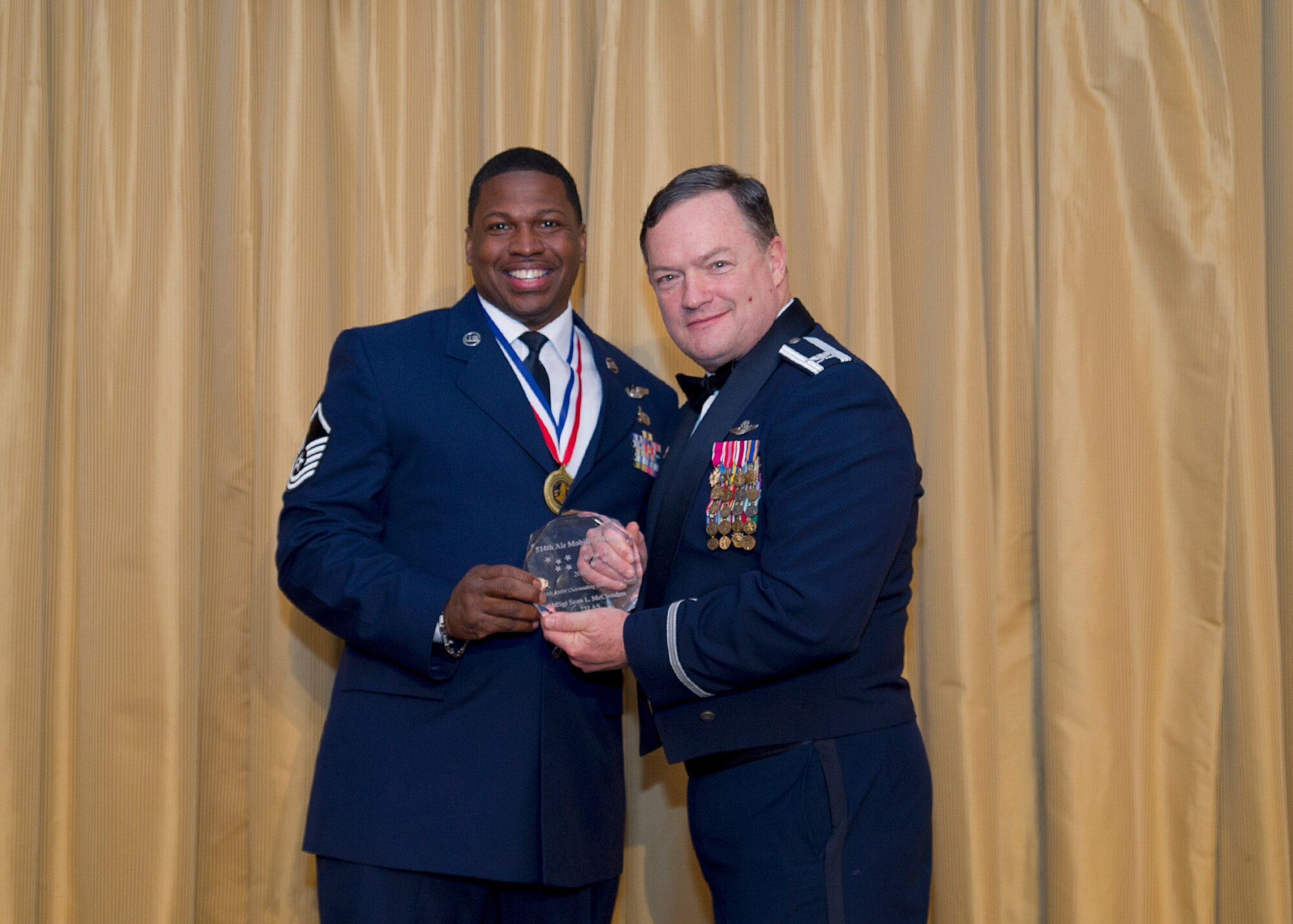 Master Sergeant Sean McClendon, 732nd Airlift Squadron, receives the Senior Non-Commissioned Officer of the year award from Col. David Pavey, 514th Air Mobility Wing commander, during the wing's annual awards banquet Feb. 11.