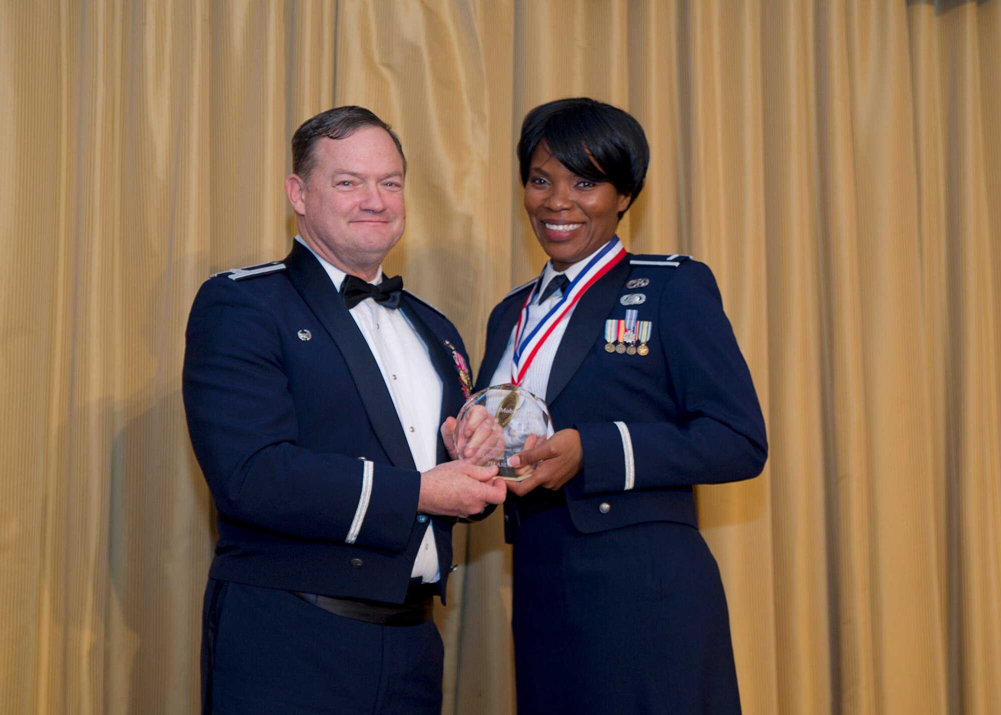 1st Lt. Melissa Torchon, 714th Aircraft Maintenance Squadron, receives the Company Grade Officer of the Year award from Col. David Pavey, 514th Air Mobility Wing commander, during the wing's annual awards banquet Feb. 11. 