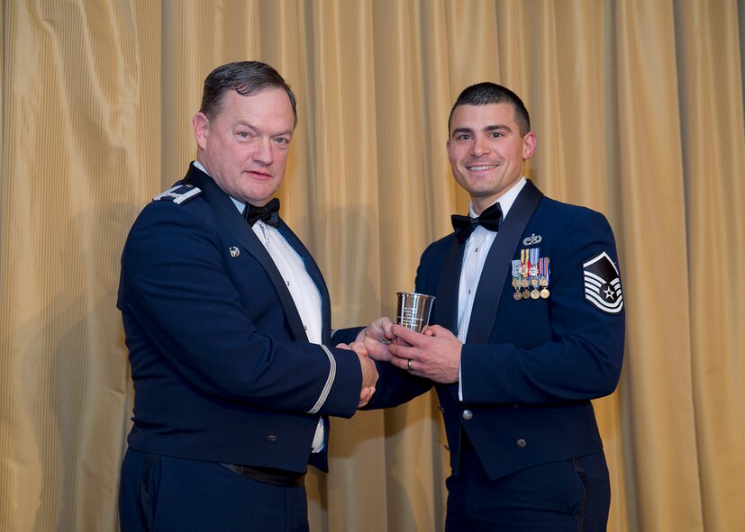 Master Sgt. Ryan Miller, 514th Maintenance Squadron receives the 514th AMW Mitchell Cup award from Col. David Pavey, 514th Air Mobility Wing commander, during the wing's annual awards banquet Feb. 11. 