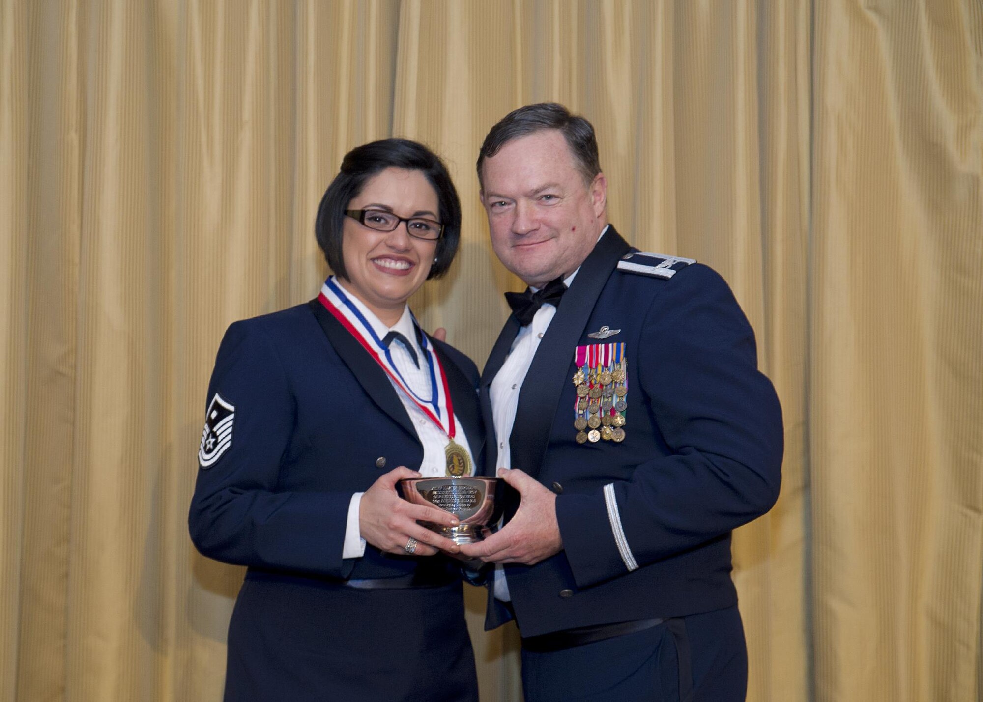 Master Sgt. Corinne Aimable, receives the Chief Kolesnikov award from Col. David Pavey, 514th Air Mobility Wing commander, during the wing's annual awards banquet Feb. 11.