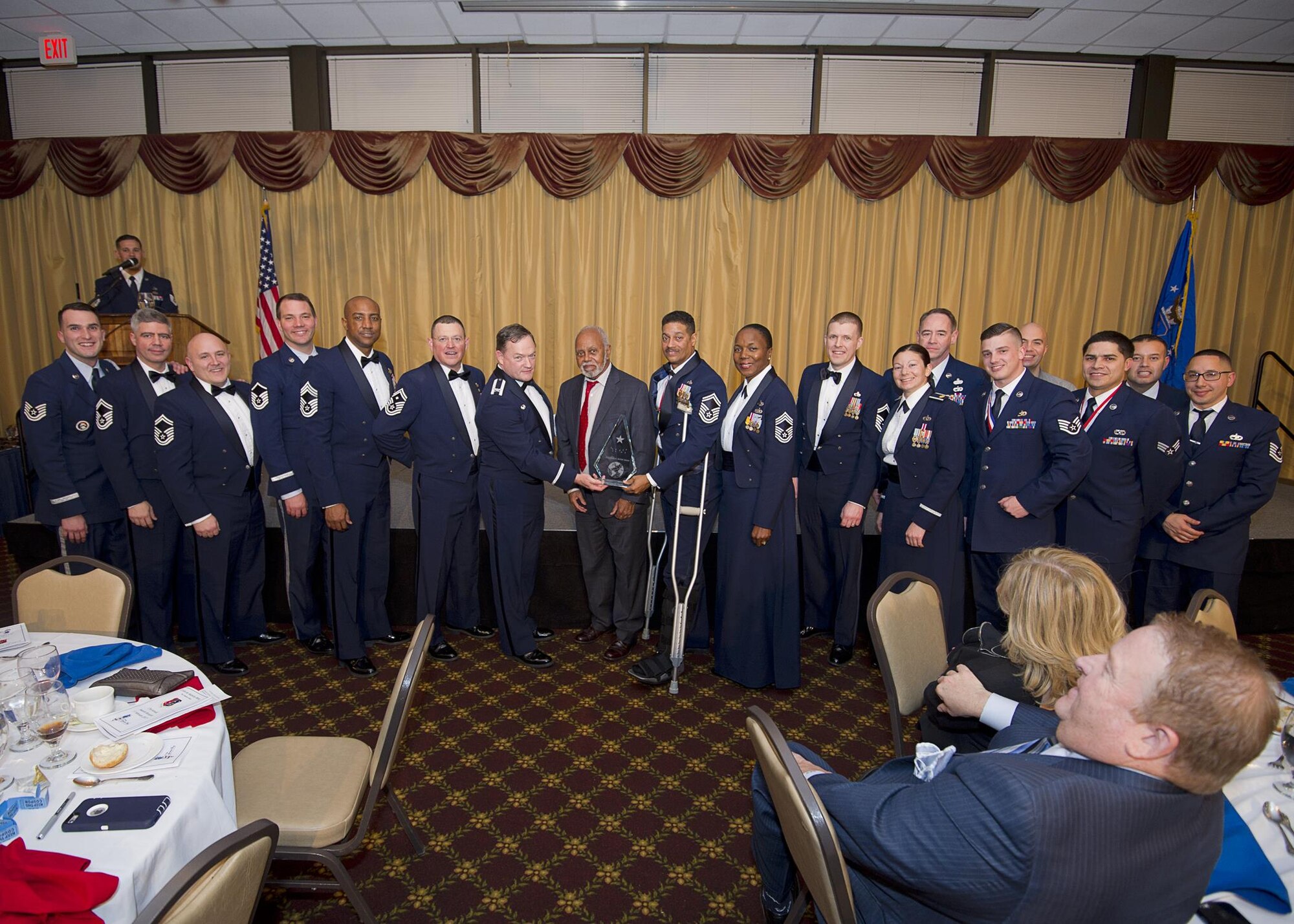 Senior Master Sgt. John Wells, 88th Aerial Port Squadron, receives the McNeil award from Col. David Pavey, 514th Air Mobility Wing commander, and Maj. Gen. (Ret.) Joseph McNeil, for whom the award is named, during the wing's annual awards banquet Feb. 11. Wells is flanked by members of his squadron.