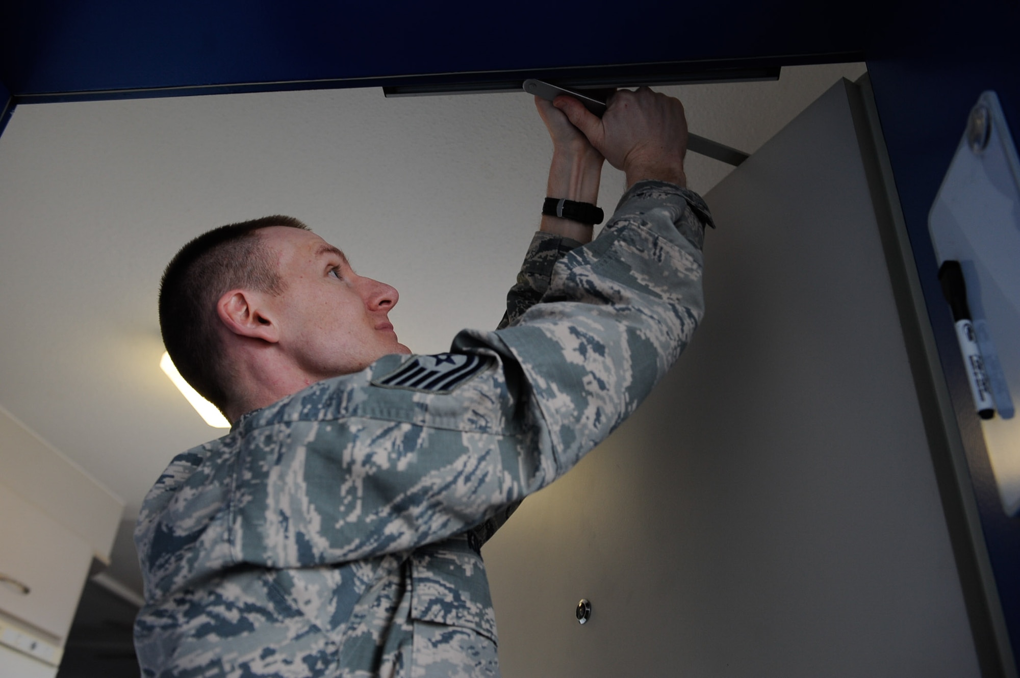 Tech. Sgt. Gentry Koepp, 86th Civil Engineering Squadron unaccompanied housing NCO in charge, inspects a dormitory door on Ramstein Air Base, Germany, Feb. 7, 2017. The Dorm Reception Center is responsible for more than 1,500 dorms on both Ramstein Air Base and Kapaun Air Station. (U.S. Air Force photo by Airman 1st Class Savannah L. Waters)