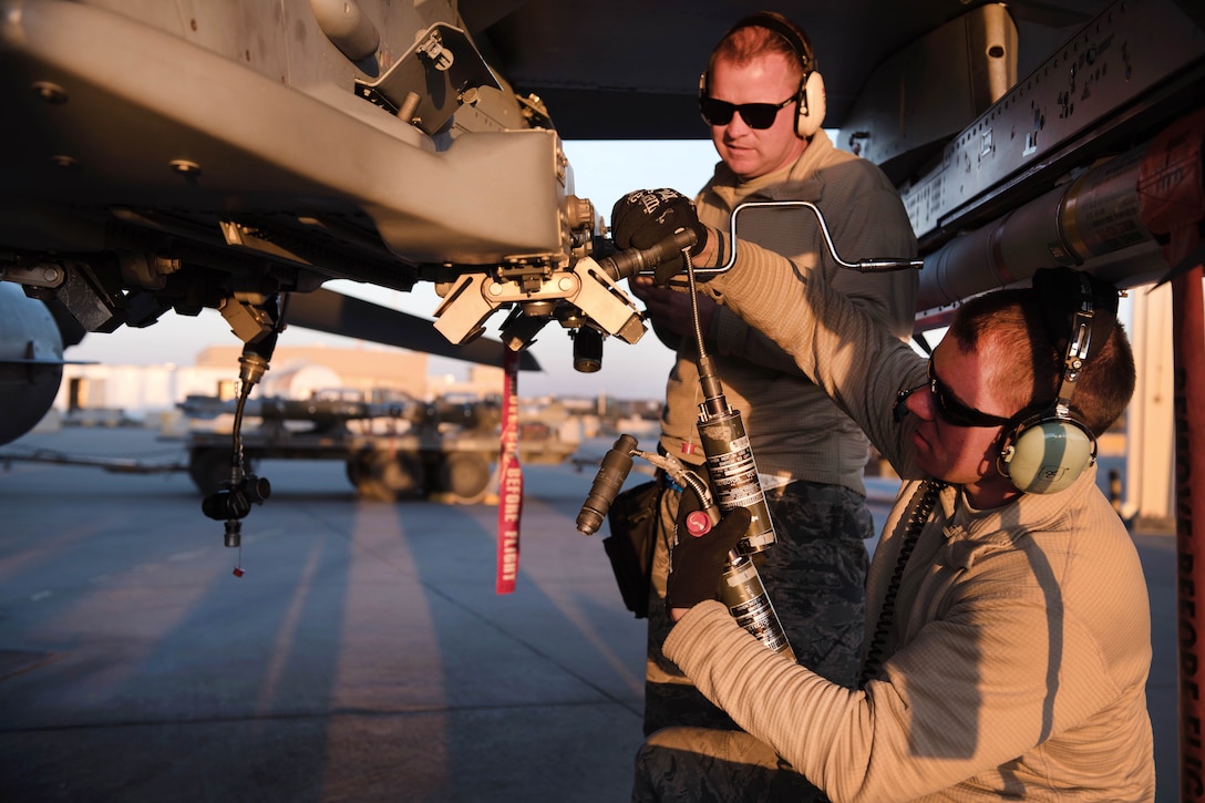 Air Force Master Sgt. Steve Frasier, left, and Tech. Sgt. Joseph Benoit test the weapons rack releasing system on an F-16 Fighting Falcon aircraft in Southwest Asia, Feb. 6, 2017. Frasier and Benoit are weapons specialists assigned to the Vermont Air National Guard’s 407th Expeditionary Maintenance Squadron. Air Force photo by Master Sgt. Benjamin Wilson