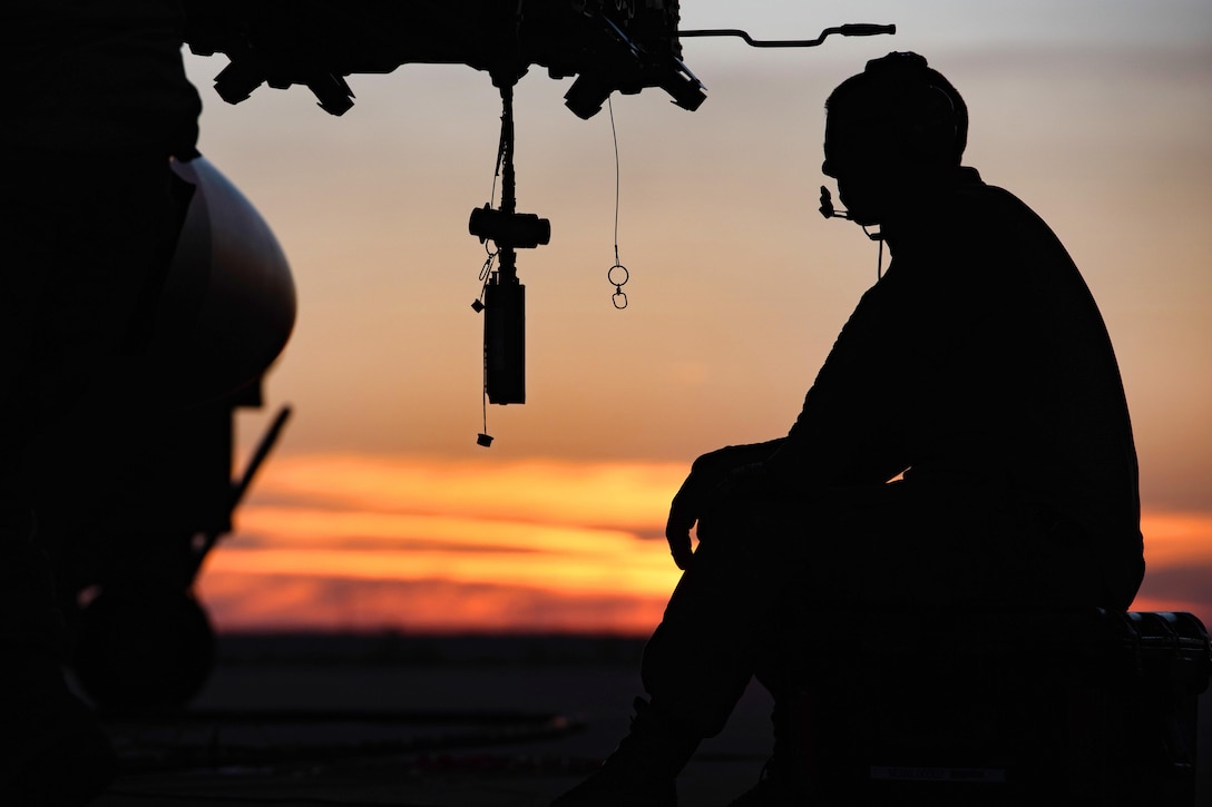 Air Force Tech. Sgt. Joseph Benoit tests the weapons rack releasing system on an F-16 Fighting Falcon aircraft at sunset in Southwest Asia, Feb. 6, 2017. Benoit is a weapons specialist assigned to the Vermont Air National Guard’s 407th Expeditionary Maintenance Squadron. Air Force photo by Master Sgt. Benjamin Wilson