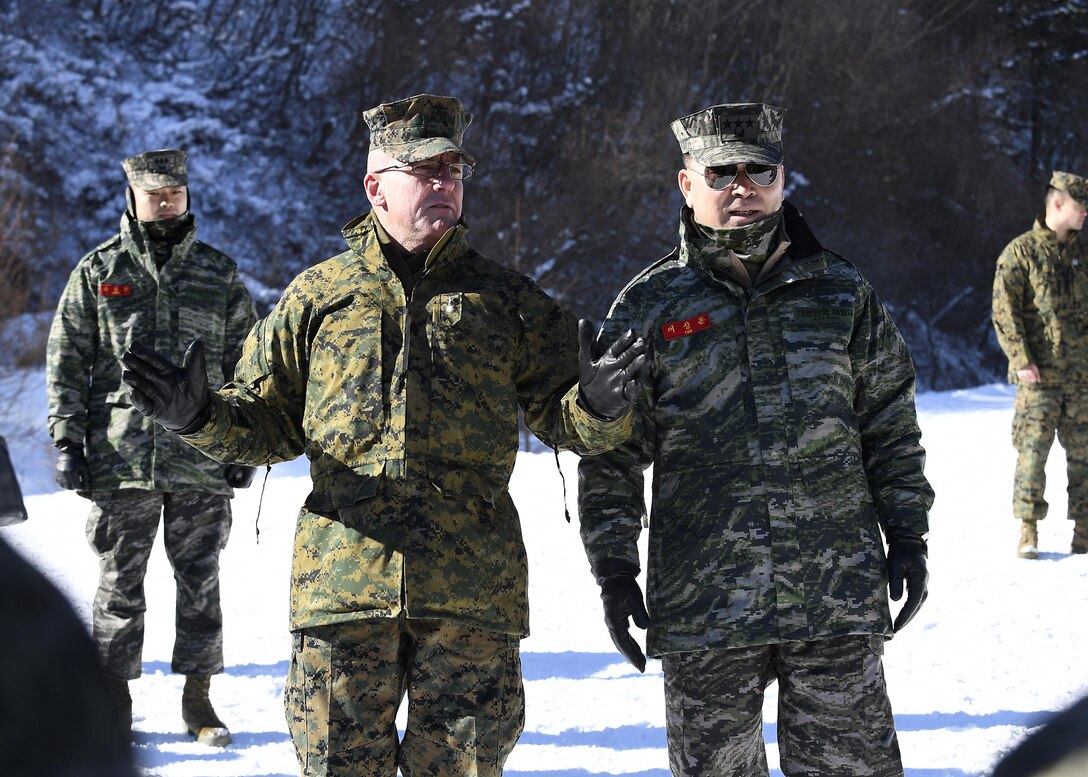 Commander of Marine Forces Korea, Maj Gen. Robert F. Hedelund, left, and Lt. Gen. Lee Sang-Hoon, commandant of the Republic of Korea Marine Corps, speak to U. S. and ROK Marines participating in KMEP 17-8.  Korean Marine Exchange Program (KMEP) is a regularly scheduled multinational exercise that focuses on the integration of aviation and ground assets within the construct of a traditional Combined Arms Live Fire Exercise and is designed to enhance the combat readiness of the U.S and Korean troops. 