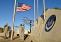 Military members of the Oklahoma City Air Logistics Complex lower the American flag from the base flag pole during an official retreat ceremony Jan. 24, 2017, Tinker Air Force Base Oklahoma. OC-ALC  conducted the retreat ceremony as part of the official Tinker AFB 75th Anniversary events. Tinker hosts the Air Force Sustainment Center and falls under the Air Force Materiel Command. The AFMC badge is displayed on the wall.  (U.S. Air Force photo/Greg L. Davis)