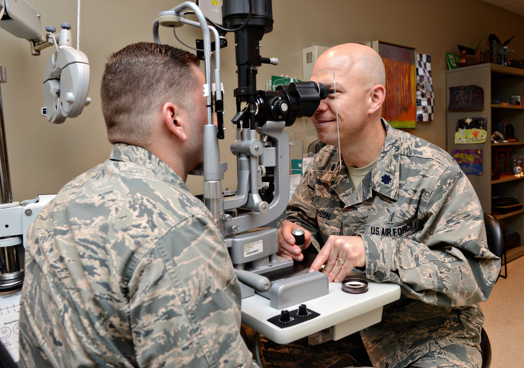 Lt. Col. Chad Simpson, the optometry flight commander with the 72nd Aerospace Medicine Squadron, performs a routine eye exam on Capt. Miles Stutes, a physical therapist with the 72nd Medical Operations Squadron. (Air Force photo by Kelly White)