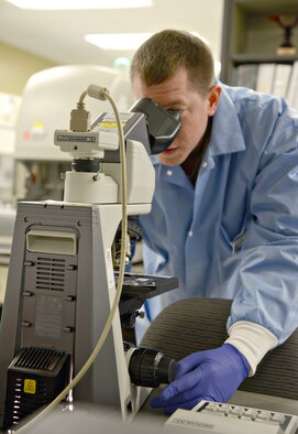 2nd Lt. Caleb Arrington, the laboratory element chief, examines CBCs (complete blood counts) through one of the lab’s microscopes. (Air Force photo by Kelly White)