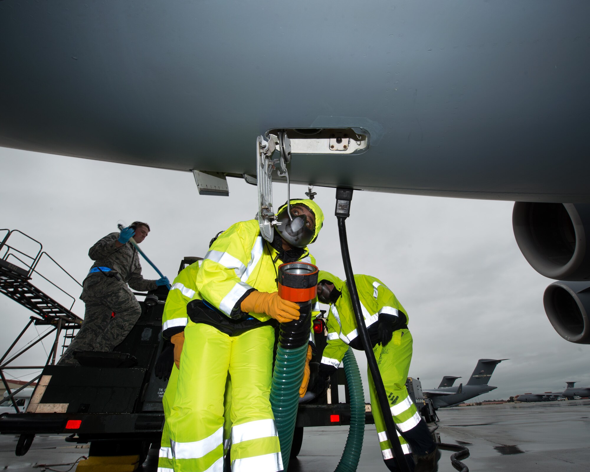 U.S. Air Force Chief Master Sgt. Shelina Frey, Air Mobility Command command chief, Scott Air Force Base Ill., hooks up a hose to a C-17 Globemaster III during her tour of the 60th Aerial Port Squadron at Travis Air Force Base, Calif., Feb. 8, 2016. Frey is on a five-day tour to Travis visiting with Airmen, observing operations and recognizing the newest chief master sergeants. (U.S. Air Force photo/Louis Briscese)