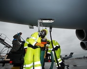 U.S. Air Force Chief Master Sgt. Shelina Frey, Air Mobility Command command chief, Scott Air Force Base Ill., hooks up a hose to a C-17 Globemaster III during her tour of the 60th Aerial Port Squadron at Travis Air Force Base, Calif., Feb. 8, 2016. Frey is on a five-day tour to Travis visiting with Airmen, observing operations and recognizing the newest chief master sergeants. (U.S. Air Force photo/Louis Briscese)