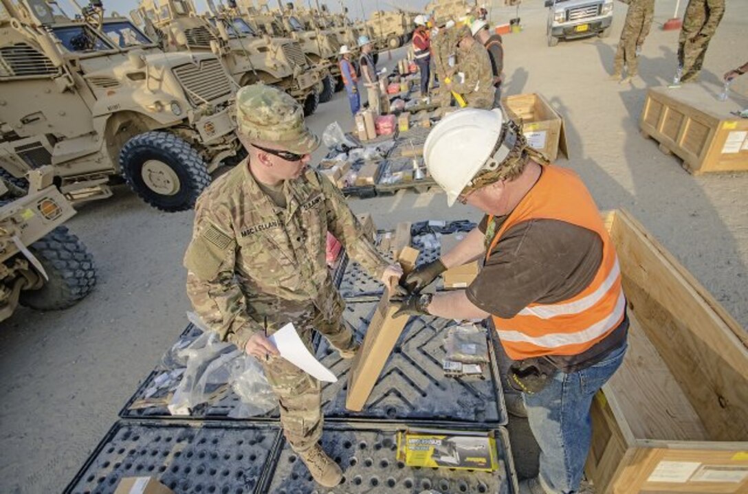 Soldiers with the 2nd Brigade Combat Team, 82nd Airborne Division verify inventory during an equipment layout led by the 401st Army Field Support Brigade at Camp Arifjan, Kuwait, Feb. 6. (U.S. Army photo by Justin Graff, 401st AFSB Public Affairs)