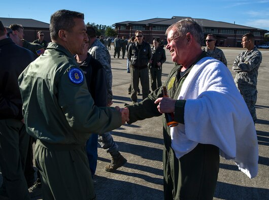 Former 315th Airlift Wing Vice Commander, Maj. Gen. Michael Kim, mobilization assistant to the Air Force Reserve Command commander, congratulations retiring Lt. Col. Rick Davis, 317th Airlift Squadron, after Davis' "fini flight" in a Charleston C-17 Globemaster III Feb. 10. (U.S. Air Force photo by Michael Dukes)
