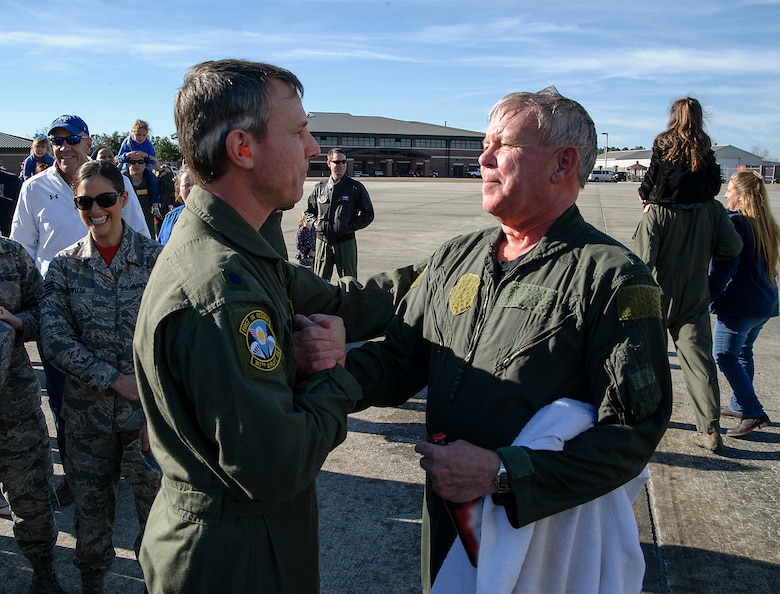 Lt. Col. Stan Davis, 317th Airlift Squadron commander, congratulates retiring Lt. Col. Rick Davis, 317th AS, after Davis' "fini flight" in a Joint Base CHarleston C-17 Feb. 10. (U.S.Air Force photo by Michael Dukes)