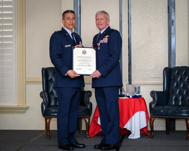 (From left) Former 315th Airlift Wing Vice Commander, Maj. Gen. Michael Kim, mobilization assistant to the Air Force Reserve Command commander, officiated over Lt. Col. Rick Davis', 317 Airlift Squadron, with a retirement certificate during his retirement ceremony at Joint Base Charleston, S.C Feb. 12. (U.S. Air Force photo by Senior Airman Tom Brading)