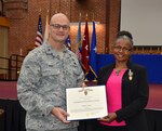 Defense Logistics Agency Aviation employee, Muriel Moss receives the Superior Civilian Service Award from DLA Aviation Commander Air Force Brig. Gen. Allan Day, for distinguishing herself as a warfighter support representative on DLA Support Team-Kuwait, Camp Arifjan, from May to November 2016, in support of Operations Freedom’s Sentinel, Inherent Resolve and Spartan Shield.  The award was presented Feb. 8, 2017, during the three-day DLA Aviation Senior Leader Conference held on Defense Supply Center Richmond, Virginia.  