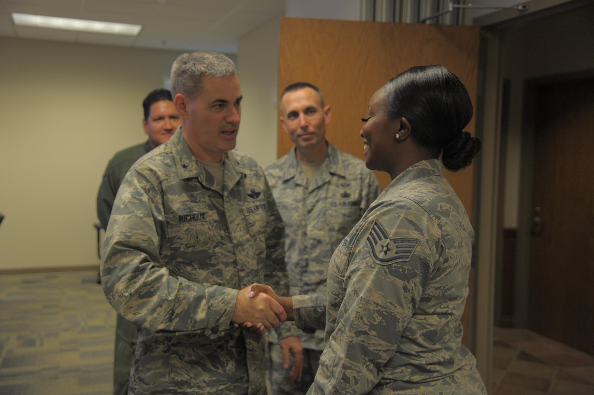 Brig. Gen. Lenny Richoux, 18th Air Force vice commander, presents a coin to Staff Sgt. Paquita Williams, 91st Air Refueling Squadron Aviation Resource Management NCO in charge, at MacDill Air Force Base, Florida, Feb. 2, 2017. Richoux met with many star performers around MacDill during his visit of the base and spoke at the 6th Air Mobility Wing’s annual-awards ceremony the following night. (U.S. Air Force photo by Airman 1st Class Adam R. Shanks)