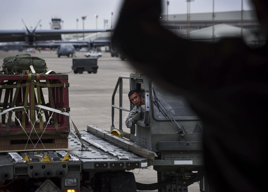 U.S. Air Force Staff Sgt. Jonathan Stager, 29th Weapons Squadron instructor loadmaster, marshals in a K-loader carrying two High Velocity Container Delivery System bundles Feb. 3, 2017, at Little Rock Air Force Base, Ark. The HVCDS bundles were dropped as part of a training exercise. (U.S. Air Force photo by Senior Airman Stephanie Serrano)