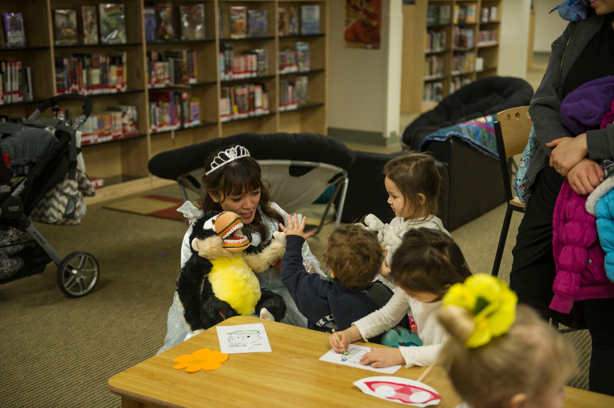 U.S. Air Force Senior Airman Shiermaine Francisco, a 354th Medical Operations Squadron dental assistant, gives a child a high-five Feb. 2, 2016, at Eielson Air Force Base, Alaska. Members of the Eielson Dental Clinic visited children to raise awareness for National Children’s Dental Health month. (U.S. Air Force photo by Airman Isaac Johnson)