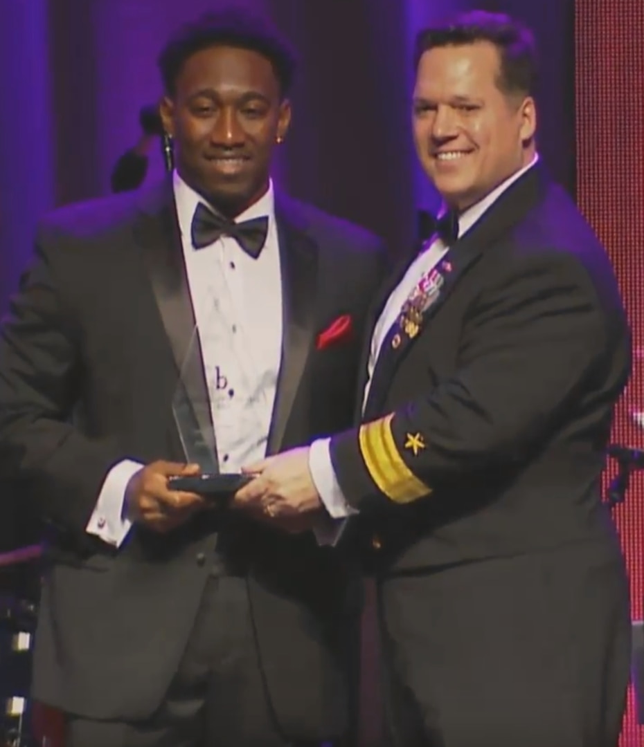 WASHINGTON (Feb. 11, 2017) - Naval Surface Warfare Center (NSWC) Commander Rear Adm. Tom Druggan presents the Black Engineer of the Year (BEYA) Community Service Award to Dwayne Nelson, NSWC Dahlgren Division engineer, at the 31st annual BEYA gala. "This award has inspired and challenged me to contribute more towards empowering our youth and others to serve our community while encouraging interest in highly-rewarding science, technology, engineering and mathematics (STEM) fields," said Nelson. "Giving back and empowering people to reach their full potential is vital to stimulating enthusiasm about STEM. Every step, no matter how large or small, helps strengthen the arduous efforts in sustaining monumental, long-term, positive change within our communities."  (U.S. Navy photo/Released)

