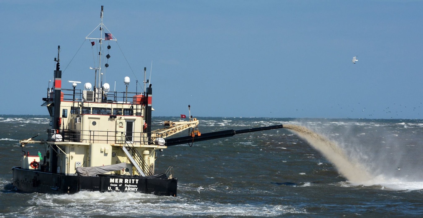 The shallowdraft, sidecast vessel MERRITT dredges the federal channel at Oregon Inlet.