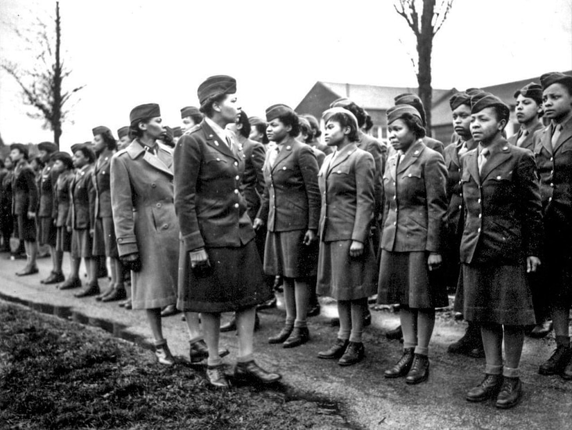 Women's Army Corps Maj. Charity Adams, 6888th Central Postal Directory Battalion commander, and Army Capt. Mary Kearney, Alpha Company commander, inspect the first soldiers from the unit to arrive in England, Feb. 15, 1945. The only all-African-American Women's Army Corps unit sent to Europe during World War II, the 6888th was responsible for clearing years' worth of backlogged mail in both England and France. National Archives photo