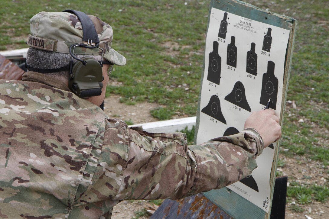 U.S. Army Reserve soldier Msg. Michael Montoya grades a Best Warrior candidates range qualification, Fort Hunter Liggett, Calif. on February 8, 2017. The candidate hit 34 out of 40 targets. 