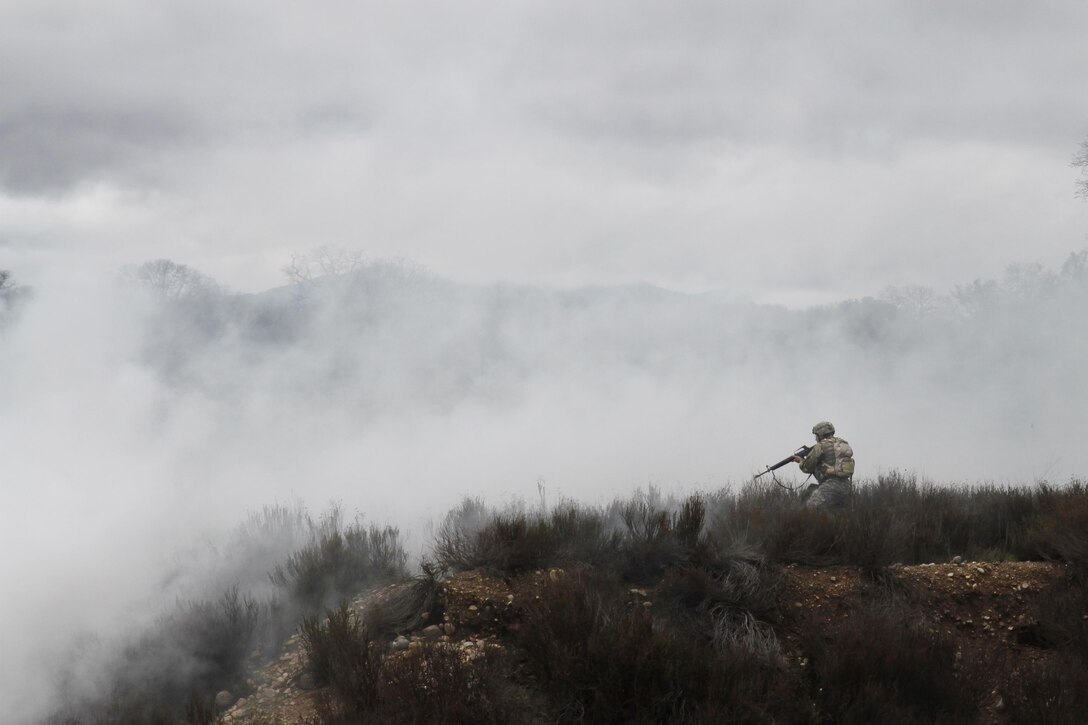 U.S. Army Reserve soldier Sgt. Juan Padilla flanks an enemy position during the Best Warrior Competition, Fort Hunter Liggett, Calif. on February 8, 2017. Padilla flanked the position of a simulated enemy in order to provide protection for his other team members. 