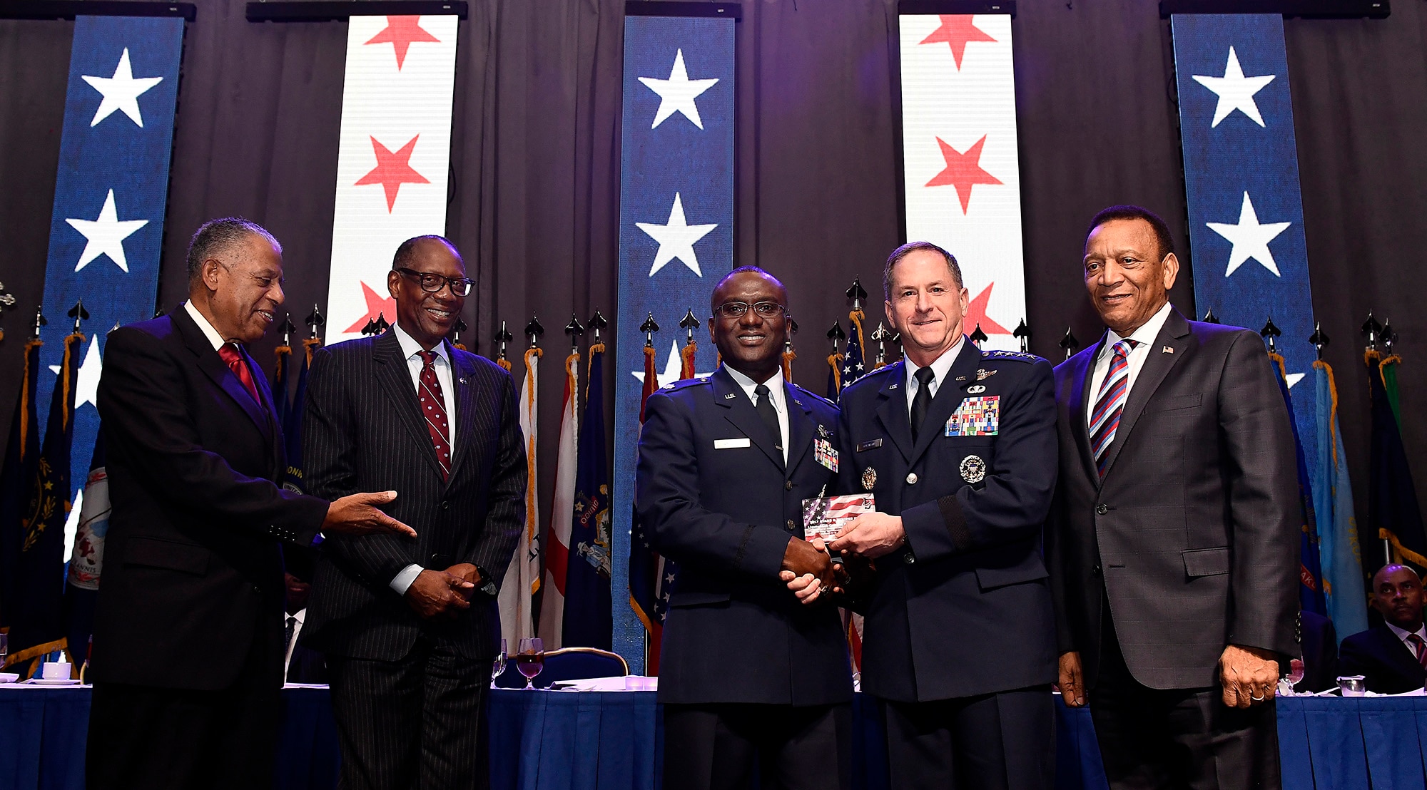 Air Force Chief of Staff Gen. David L. Goldfein, second from right, presents the Air Force Black Engineer of the Year Award to Lt. Col. Eric Amissah during the Black Engineer of the Year Awards Science, Technology, Engineering and Mathematics Conferences' Stars and Stripes ceremony Feb. 10, 2017, in Washington, D.C. (U.S. Air Force photo/Scott M. Ash)