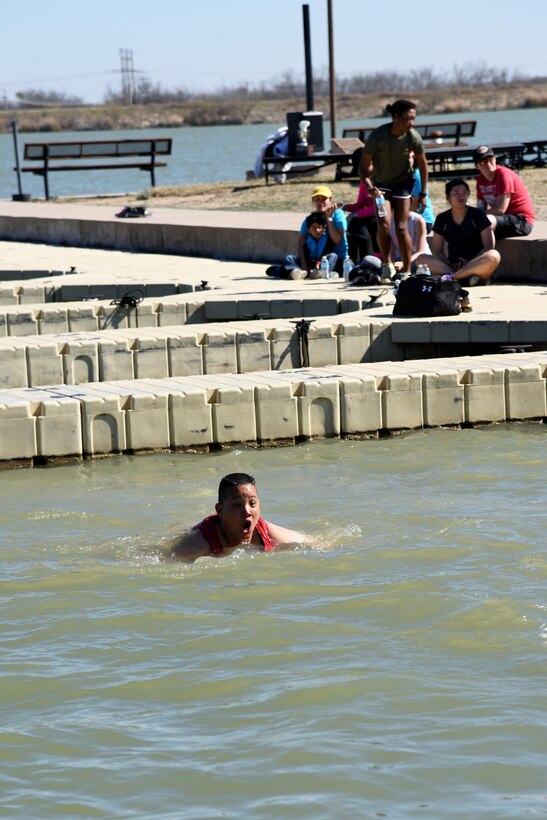 U.S. Air Force Lt. Col. Abraham Salomon, 17th Training Support Squadron Commander, swims in Lake Nasworthy during the Polar Bear Party at the Goodfellow Air Force Base Recreation Camp in San Angelo, Texas, Feb. 11, 2017. Even though it was 82 degrees outside, swimmers said the water was chilly. (U.S. Air Force photo by Staff Sgt. Joshua Edwards/Released)